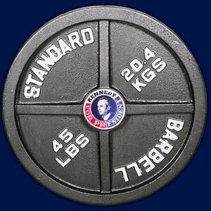 A weightlifting barbell plate with a Robert F. Kennedy Jr. campaign pin