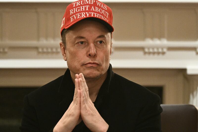 Elon Musk puts his hands together.