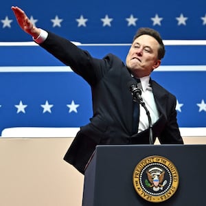 Elon Musk gestures in a move that looks like a Nazi salute as he speaks during the inaugural parade inside Capitol One Arena, in Washington, DC.