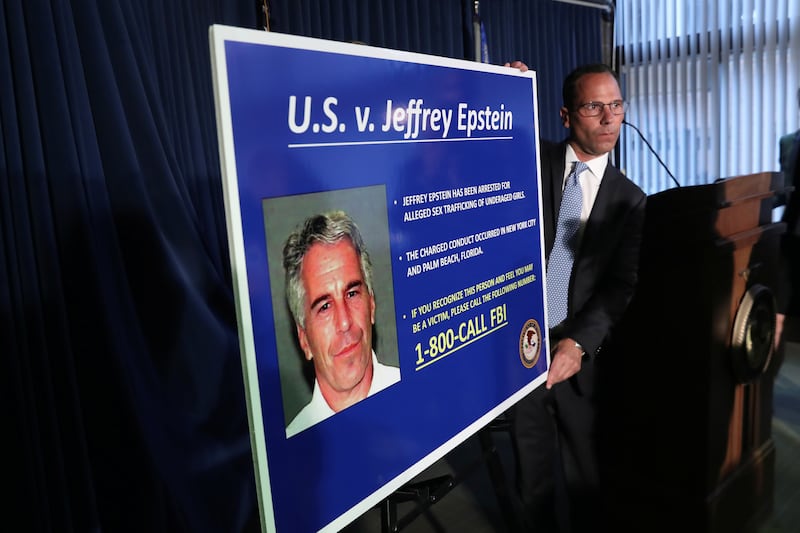 An employee of the Southern District of New York prepares a poster detailing the charges against Jeffrey Epstein—sex trafficking of minors and conspiracy to commit sex trafficking of minors—following his arrest in New York City on July 8, 2019.
