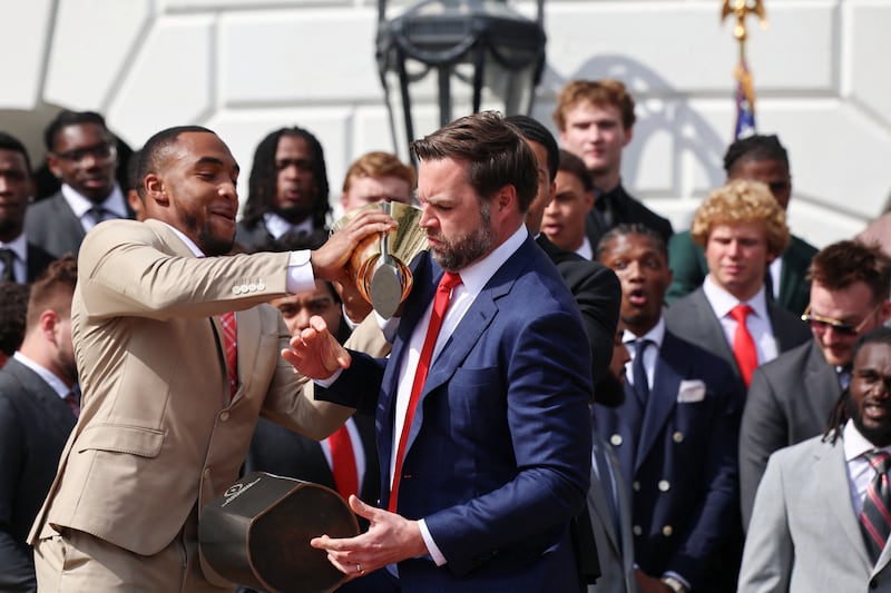 Vance awkwardly dropped the the trophy and let it tumble to the ground.