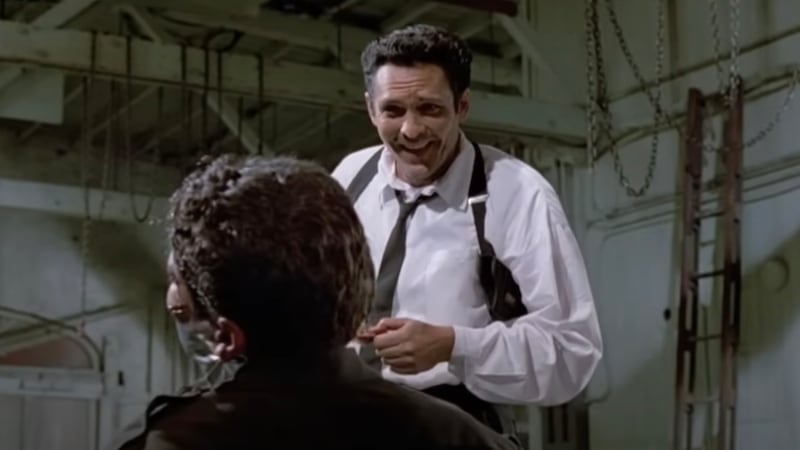 Mr. Blonde, played by Madsen, cuts off Marvin's (Kirk Baltz) ear with his razor in a scene from Tarantino's ‘Reservoir Dogs’ (1992).