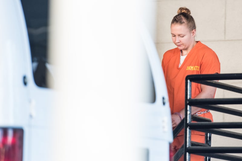 Wearing an orange prison jumpsuit, Reality Winner exits a courthouse in Augusta, Georgia on June 8, 2017.