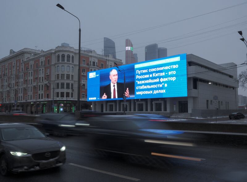 Cars drive past an electronic screen, which shows an image of Russian President Vladimir Putin and a quote from his annual televised year-end press conference and phone-in, in a street in Moscow, Russia December 19, 2024. The message reads: "The alliance of Russia and China is the most important factor of stability in world affairs". REUTERS/Shamil Zhumatov