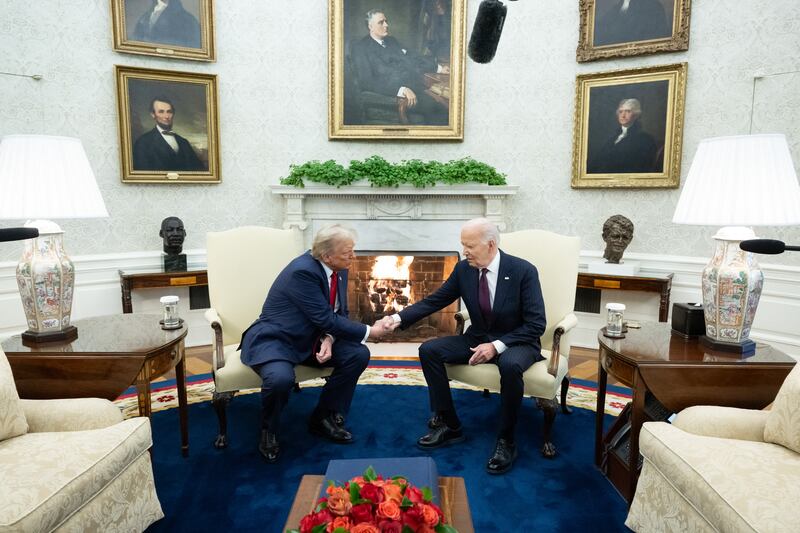 US President Joe Biden shakes hands with US President-elect Donald Trump during a meeting in the Oval Office of the White House in Washington, DC, on November 13, 2024.