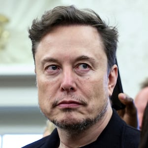 FILE PHOTO: Elon Musk looks on as U.S. President Donald Trump meets South African President Cyril Ramaphosa in the Oval Office of the White House in Washington, D.C., U.S., May 21, 2025. REUTERS/Kevin Lamarque   TPX IMAGES OF THE DAY/File Photo