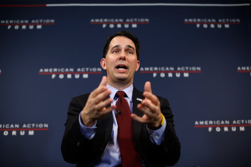 The event's moderator, former Wisconsin Governor Scott Walker, appeared peeved by the interruptions.