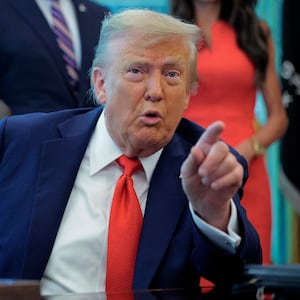 President Donald Trump talks to journalists after signing executive orders in the Oval Office at the White House on August 25, 2025 in Washington, DC.