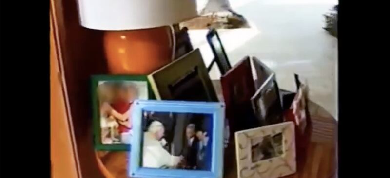 Amid a series of framed photos displayed in Jeffrey Epstein's Palm Beach mansion, one shows Epstein and Ghislaine Maxwell greeting Pope John Paul II.