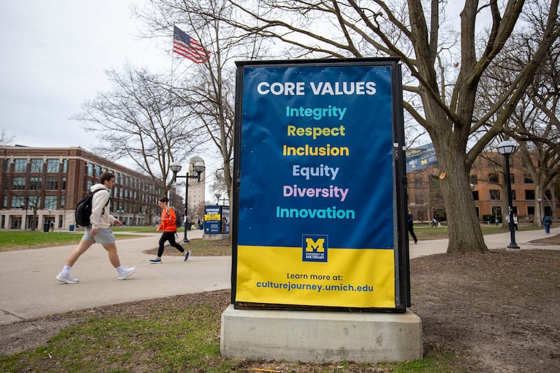 ANN ARBOR, MICHIGAN - APRIL 3: University of Michigan students walk on the UM campus next to signage displaying the University's "Core Values" on April 3, 2025 in  Ann Arbor, Michigan. Last week, the University stated it was closing its Office of Diversity, Equity and Inclusion, Office of Healthy Equity and Inclusion, and its DEI 2.0 Strategic Plan, all in response to President Donald Trump's Executive Orders concerning DEI. (Photo by Bill Pugliano/Getty Images)