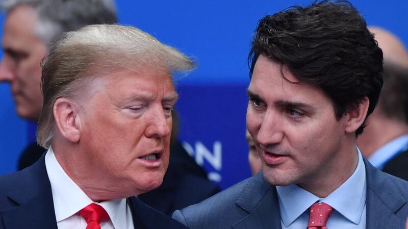 TOPSHOT - US President Donald Trump (L) talks with Canada's Prime Minister Justin Trudeau during the plenary session of the NATO summit at the Grove hotel in Watford, northeast of London on December 4, 2019. (Photo by Nicholas Kamm / AFP) (Photo by NICHOLAS KAMM/AFP via Getty Images)