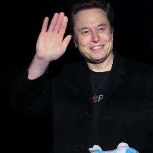 Elon Musk holds a stuffed toy
