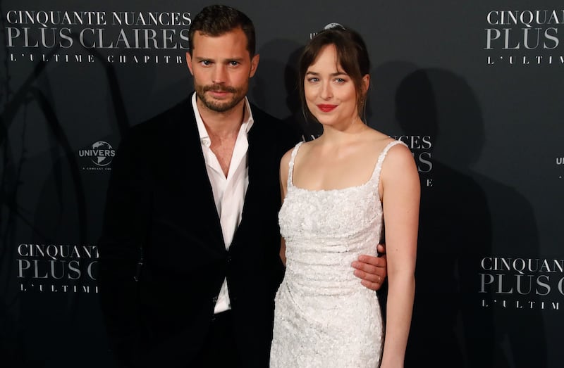 Actor Jamie Dornan and actress Dakota Johnson pose
