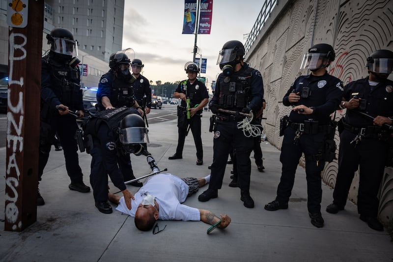Los Angeles, CA - June 06: LAPD clear the streets and checks on a man that fell down as protesters gather in response to ICE raids in Los Angeles on Friday, June 6, 2025 in Los Angeles, CA. (Jason Armond / Los Angeles Times via Getty Images)