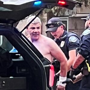 Law enforcement officers detain a suspect, after an attack that injured multiple people, in Boulder, Colorado,.