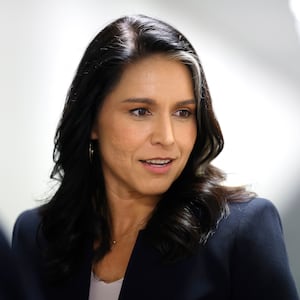 Tulsi Gabbard leaves a meeting with a Senate Republican in December.