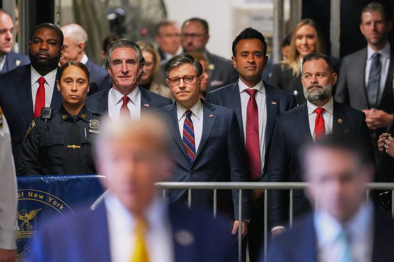 TOPSHOT - (L-R) US Representative Byron Donalds, Republican of Florida, Governor of North Dakota Doug Burgum, US Speaker of the House Mike Johnson, former presidential candidate Vivek Ramaswamy and US Representative Cory Mills, Republican of Florida, listen as former President Donald Trump speaks to reporters as he arrives to attend his trial for allegedly covering up hush money payments linked to extramarital affairs, at Manhattan Criminal Court in New York City, on May 14, 2024.