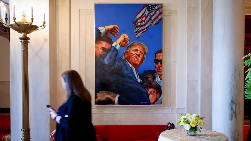 WASHINGTON, DC - APRIL 15: A painting depicting the Associated Press photograph of the aftermath of the assassination attempt on then U.S. Presidential candidate Donald Trump in Butler, Pennsylvania hangs in the Entrance Hall of the White House on April 15, 2025 in Washington, DC. The painting has recently replaced the White House portrait of former U.S. President Barack Obama. (Photo by Win McNamee/Getty Images)