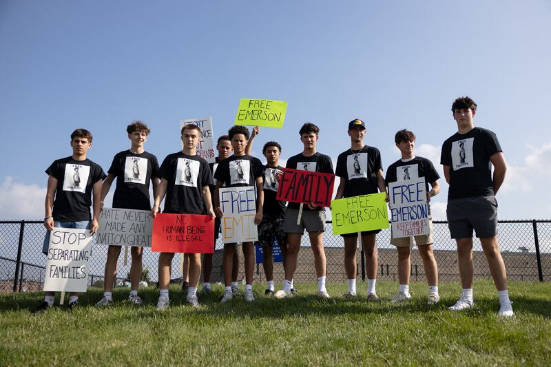 Friends of Emerson Colindres holding protest signs.