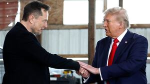 Elon Musk shakes hands with Donald Trump