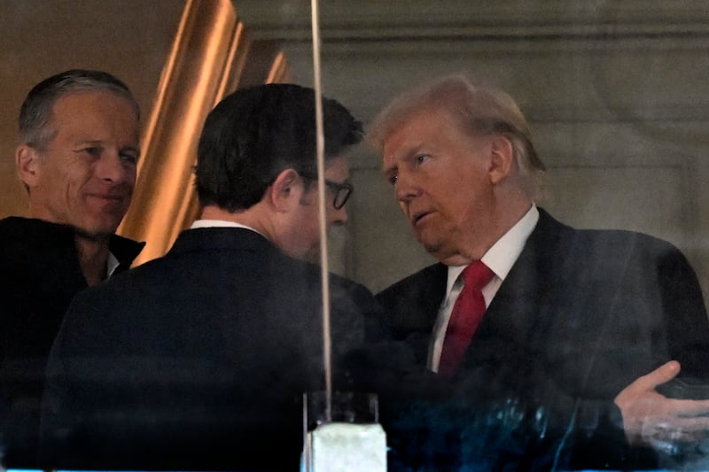 LANDOVER, MD - DECEMBER 14: President Elect Donald Trump, right, talks with Sen. John Thune, R-S.D., left, and Speaker of the House Mike Johnson during the Army-Navy football game at Northwest Stadium in Landover, MD on December 14, 2024. (Photo by John McDonnell/ for The Washington Post via Getty Images)