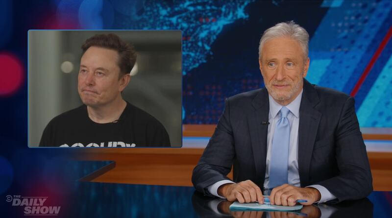 Jon Stewart showing a pic of Elon Musk looking depressed