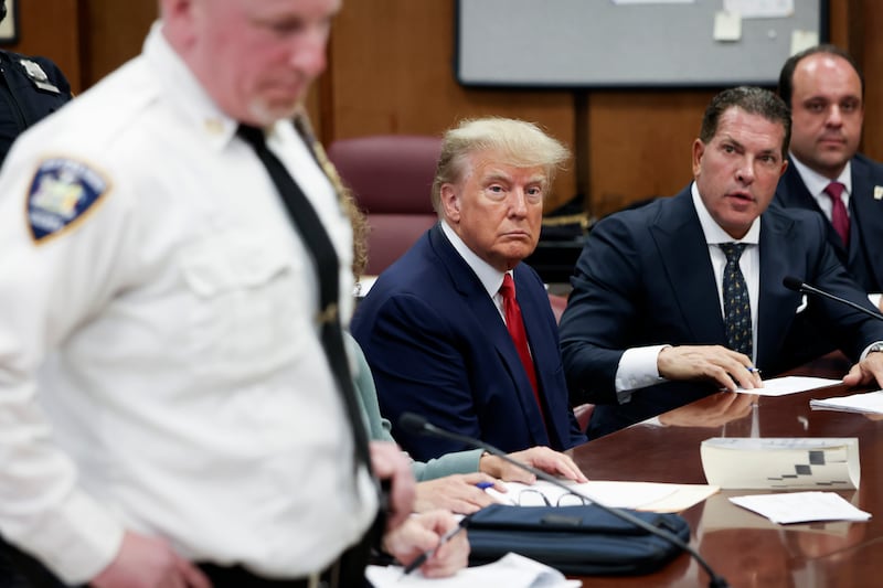 Former U.S. President Donald Trump sits in the courtroom with his attorneys Joe Tacopina and Boris Epshteyn (R) during his arraignment at the Manhattan Criminal Court April 4, 2023 in New York City.