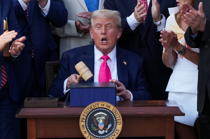 U.S. President Donald Trump reacts, while he holds a gavel, on the day he signs the sweeping spending and tax legislation, known as the "One Big Beautiful Bill Act," at the White House in Washington, D.C., U.S., July 4, 2025. REUTERS/Ken Cedeno