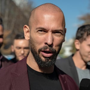 Andrew Tate addresses reporters outside a court in Bucharest, Romania, in October.