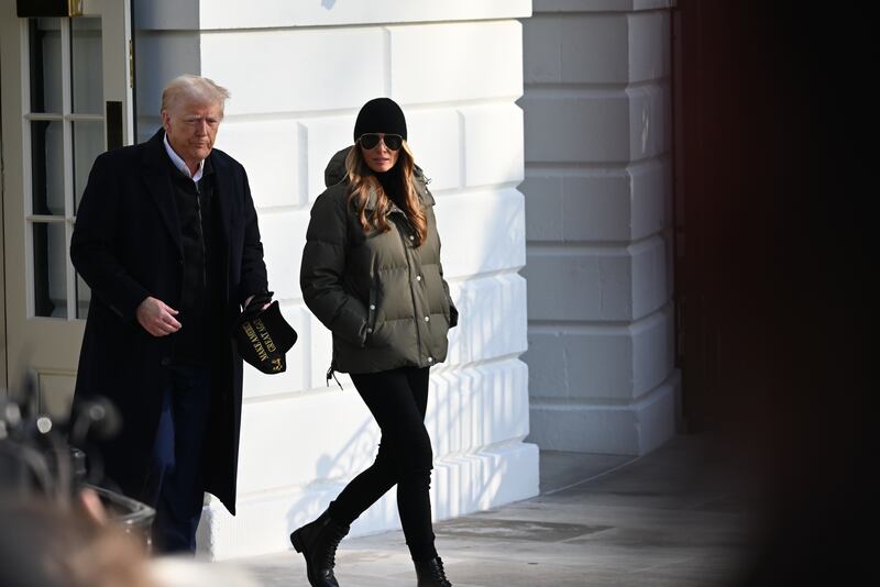 WASHINGTON, D.C., UNITED STATES - JANUARY 24: President of the United States Donald J. Trump takes questions from the press with First Lady of the United States Melania Trump by his side on the South Lawn of the White House prior to departing on Marine One for the first trip of his second term to North Carolina and California in Washington, D.C., United States on January 24, 2025. (Photo by Kyle Mazza/Anadolu via Getty Images)