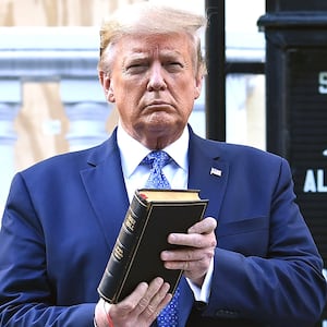 Donald Trump holds up a Bible outside of St John's Episcopal church across Lafayette Park in Washington, DC on June 1, 2020.