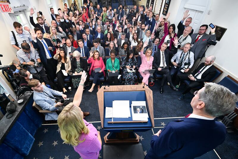 Reporters in the White House press briefing raise their hands to ask questions as White House Press Secretary Karoline Leavitt decried the press coverage of President Trump's first 100 days on Tuesday April 29, 2025.