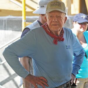 Former president Jimmy Carter helps build a house as he visits the construction site run by his Habitat for Humanity foundation for victims of the January 2010 earthquake in Leogane, Haiti on November 26, 2012.
