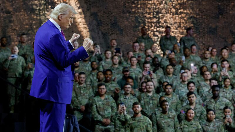 Donald Trump gestures while speaking to U.S. troops at an Air Base in Doha, Qatar