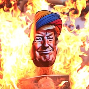 Members of India's main opposition party, the National Congress, burn an effigy of U.S. President Donald Trump in Kolkata, India, on May 14, 2025. They protest against America's interference in Indian internal affairs and the grouping of India and Pakistan in the same bracket regarding the recent war issue. (Photo by Gautam Bose/NurPhoto via Getty Images)