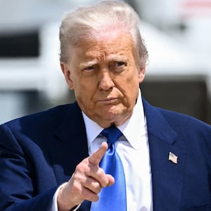 US President Donald Trump gestures as he walks to board Air Force One at Joint Base Andrews in Maryland on May 12, 2025. President Trump is travelling to the Middle East, where Saudi Arabia will be the first stop on a four-day trip. (Photo by Brendan SMIALOWSKI / AFP) (Photo by BRENDAN SMIALOWSKI/AFP via Getty Images)