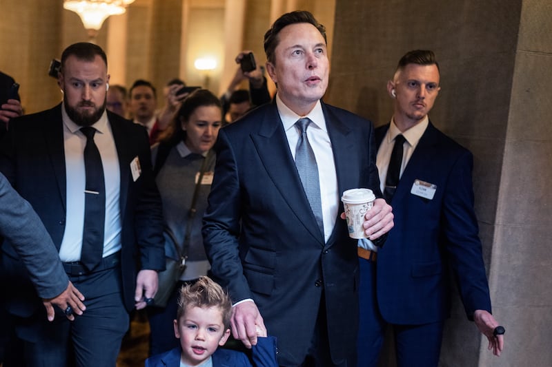Elon Musk and his son are seen in the U.S. Capitol after a meeting with Sen. John Thune, R-S.D., Dec. 5, 2024.