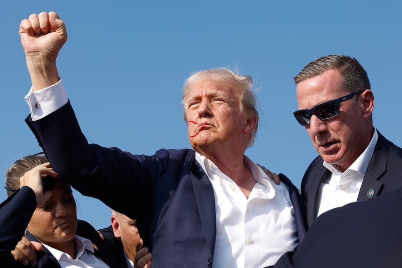 Donald Trump pumps his fist as he is rushed offstage during a rally on July 13, 2024 in Butler, Pennsylvania.