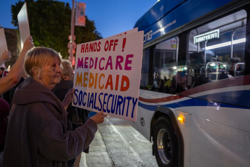 An old woman protests out of fear of SSA cuts.