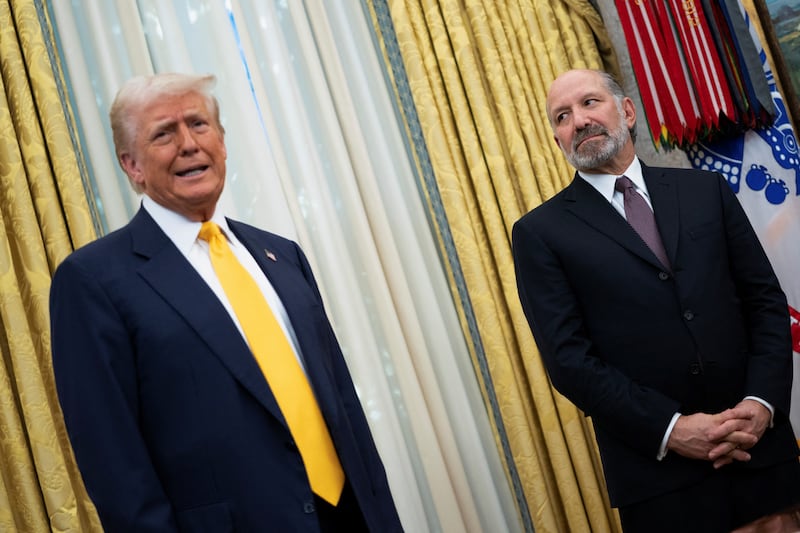 U.S. President Donald Trump speaks alongside Howard Lutnick in the Oval Office of the White House on the day Lutnick is sworn in as U.S. Commerce Secretary by U.S. Vice President JD Vance, in Washington, D.C., U.S., February 21, 2025.
