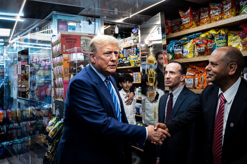 Trump shakes hands with Francisco Marte at Sanaa Convenient.