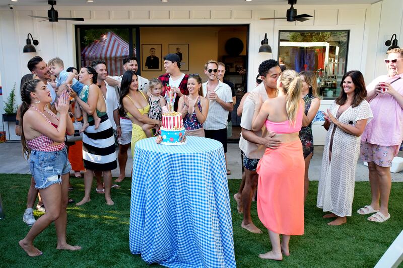A group shot of people in a backyard in a still from ‘The Valley’