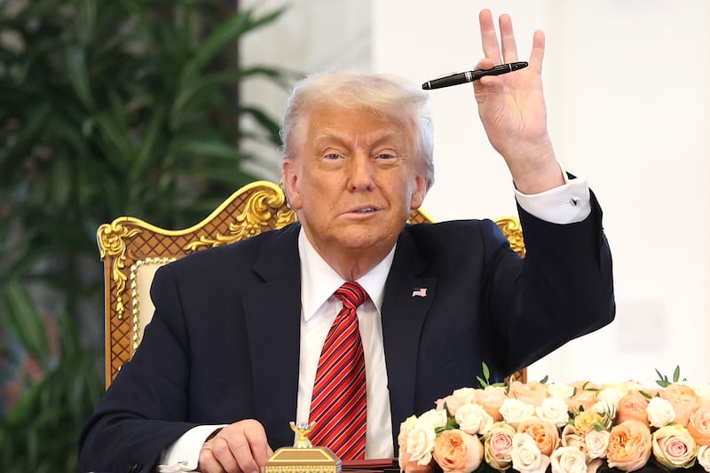 DOHA, QATAR - MAY 14:  U.S. President Donald J. Trump attends a signing ceremony at the Amiri Diwan, the official workplace of the emir, on May 14, 2025, in Doha, Qatar. The visit underscores the strategic partnership between the United States and Qatar, focusing on regional security and economic collaboration.  (Photo by Win McNamee/Getty Images)
