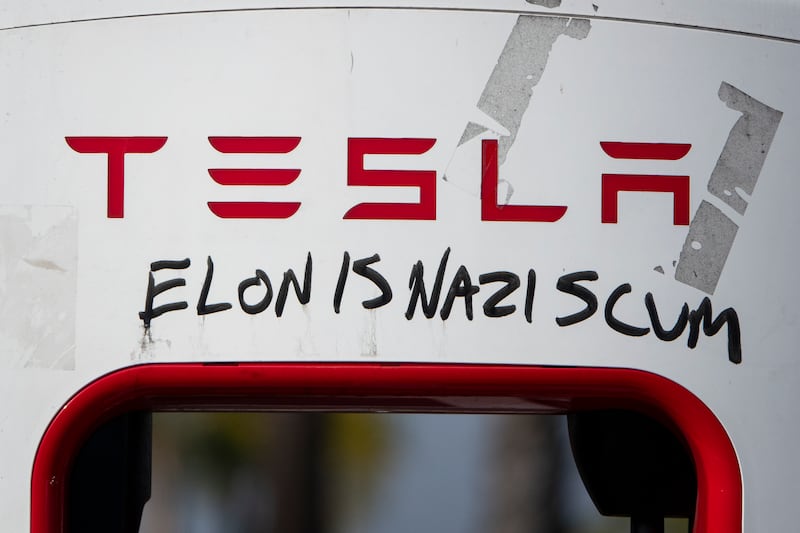 SAN DIEGO, CALIFORNIA - JANUARY 31: A Tesla Supercharger station is vandalized with the words Elon is a Nazi scum on January 31, 2025 in San Diego, California.