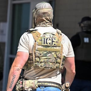 Masked law enforcement officers, including HSI and ICE agents, walk into an immigration court in Phoenix, Arizona, U.S., May 21, 2025.