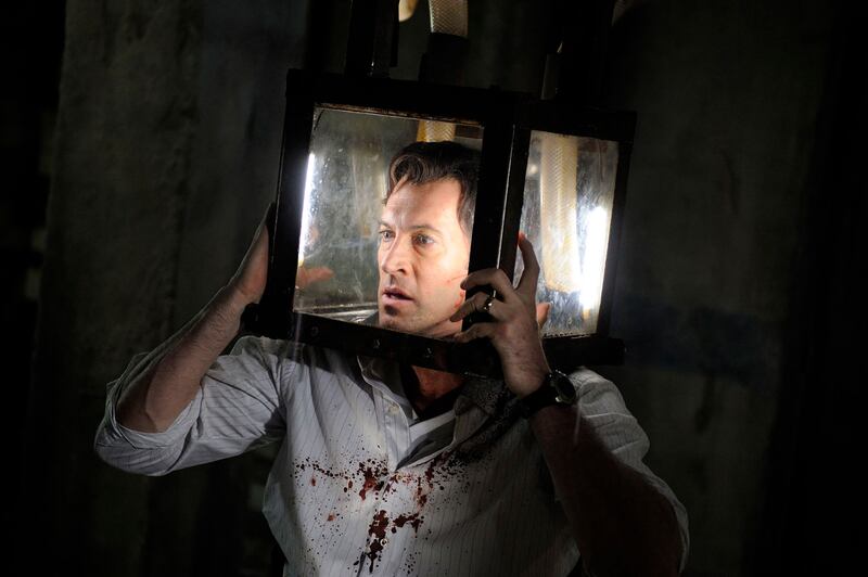 Scott Patterson in 'Saw V' with a box on his head