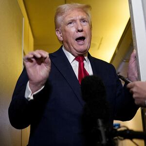 U.S. President Donald Trump speaks to members of the media onboard Air Force One, on a flight to Joint Base Andrews in Maryland, U.S. April 13, 2025. REUTERS/Nathan Howard     TPX IMAGES OF THE DAY