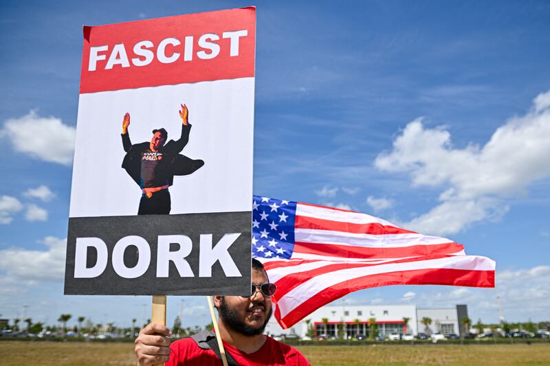 Demonstrators rally during a "Tesla Takedown" protest in Clermont, Florida, on March 29, 2025.