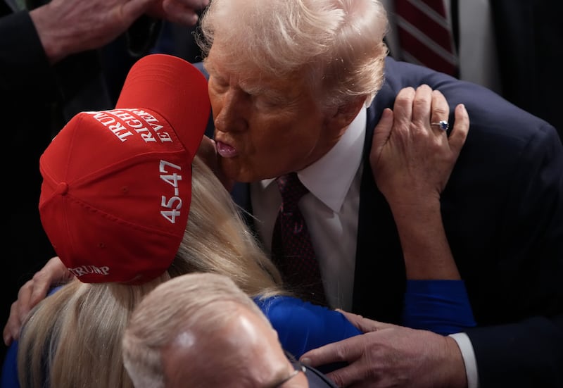 Donald Trump kisses Greene after addressing a joint session of Congress at on March 4, 2025.