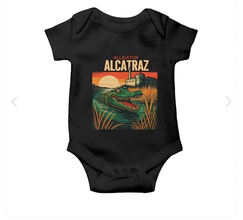 A baby onesie sold online ahead of Donald Trump's visit to the "Alligator Alcatraz" migrant detention centre.
